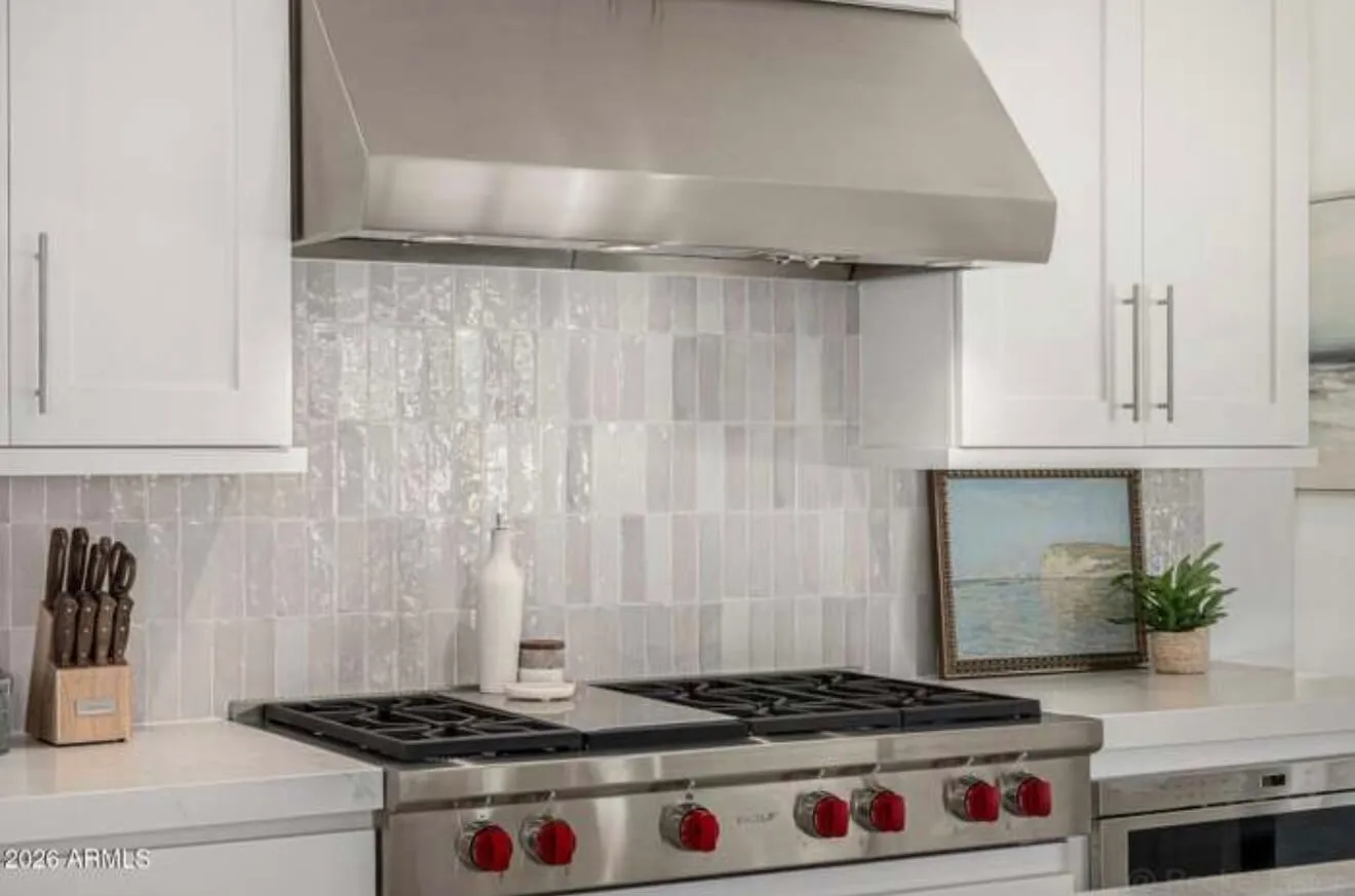 Clean stovetop and backsplash after kitchen cleaning
