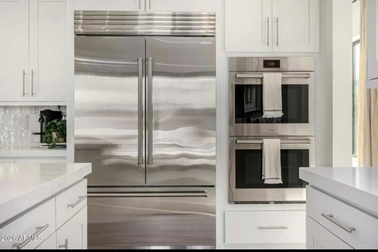 Clean refrigerator and oven exterior after service