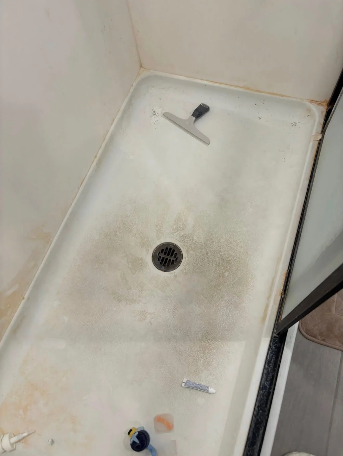 Shower pan before AZ Glitz and Glam bathroom cleaning