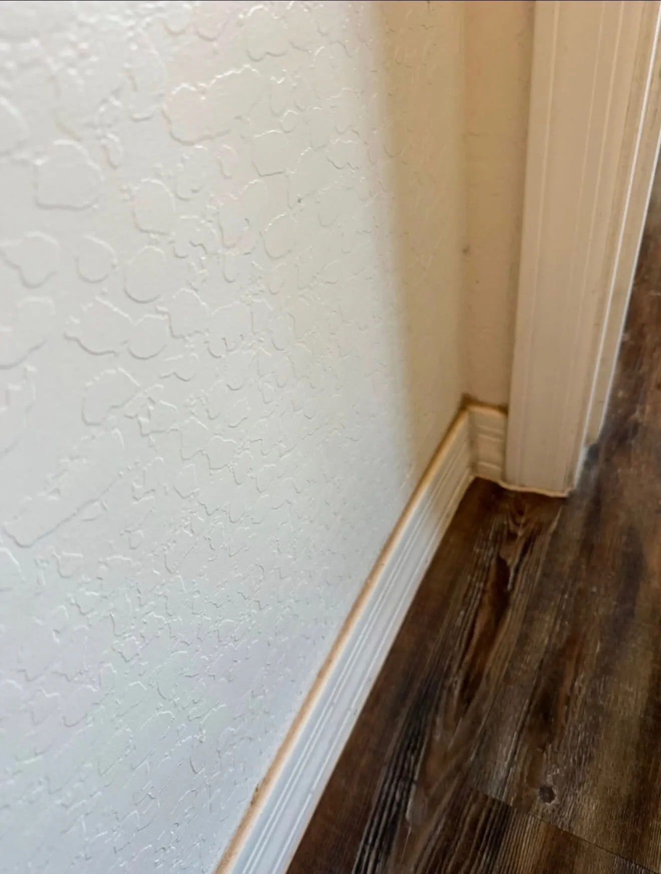 Baseboard corner before detailed cleaning